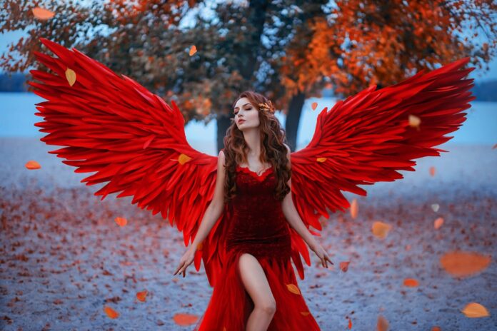 Young,Beautiful,Fantasy,Woman,Fallen,Angel,Stands,Near,Tree,,Orange