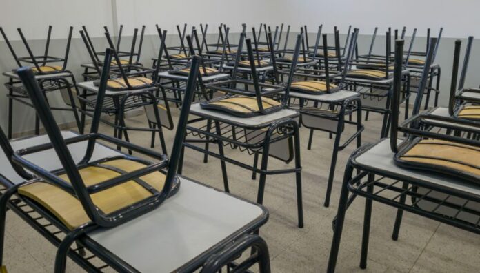 Empty tables and chairs in a school. Teacher strike concept.